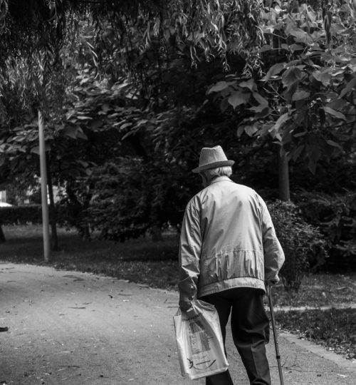 grayscale-back-view-photo-of-elderly-man-with-cane-walking-2586537